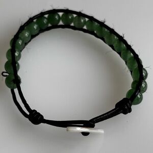 Green beaded bracelet /black cord/ button & hole closure/first wrist size 6.5 in